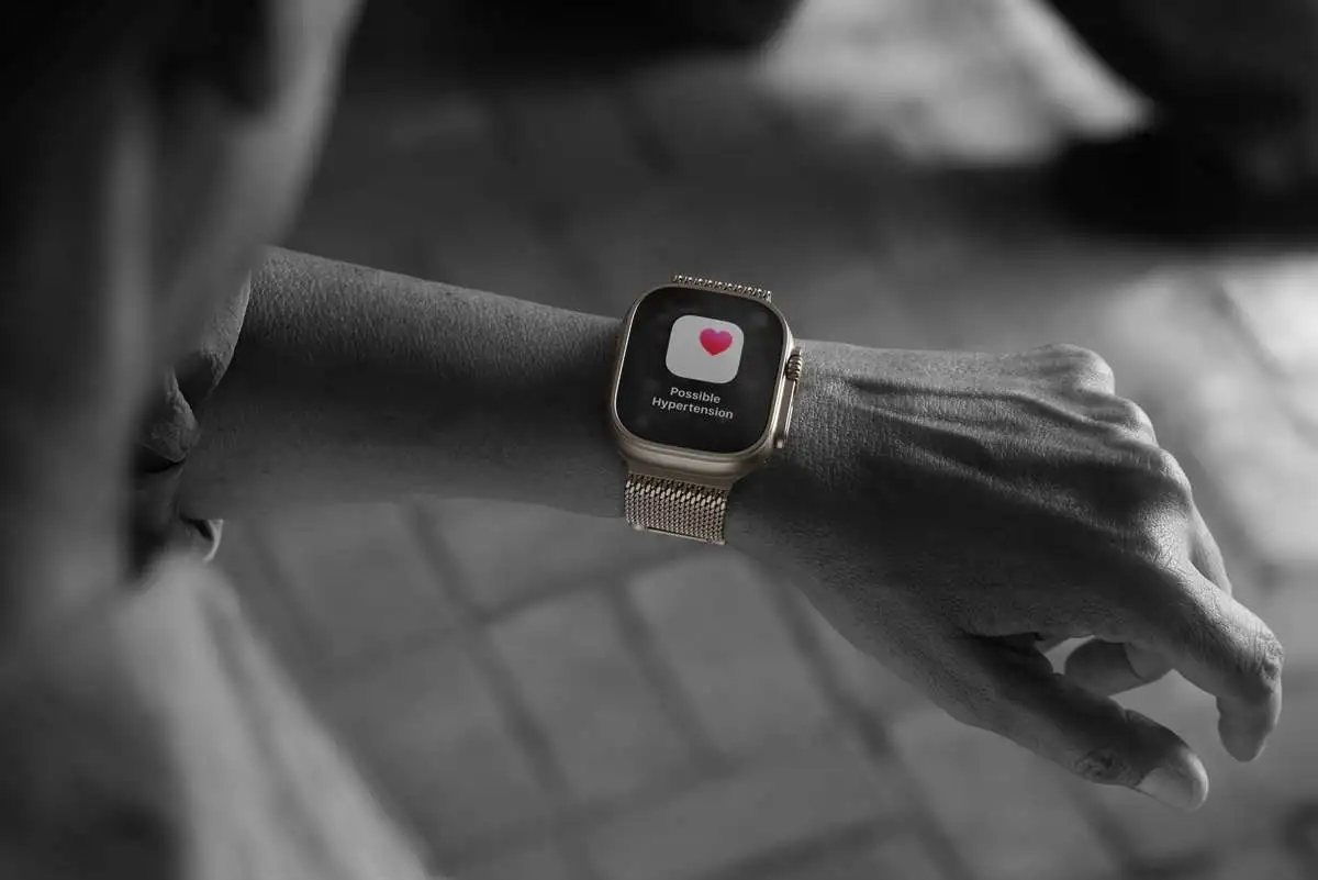 An Apple Watch worn on the wrist showing a Possible Hypertension alert, the kind of warning hypertension notifications on Apple Watch produce