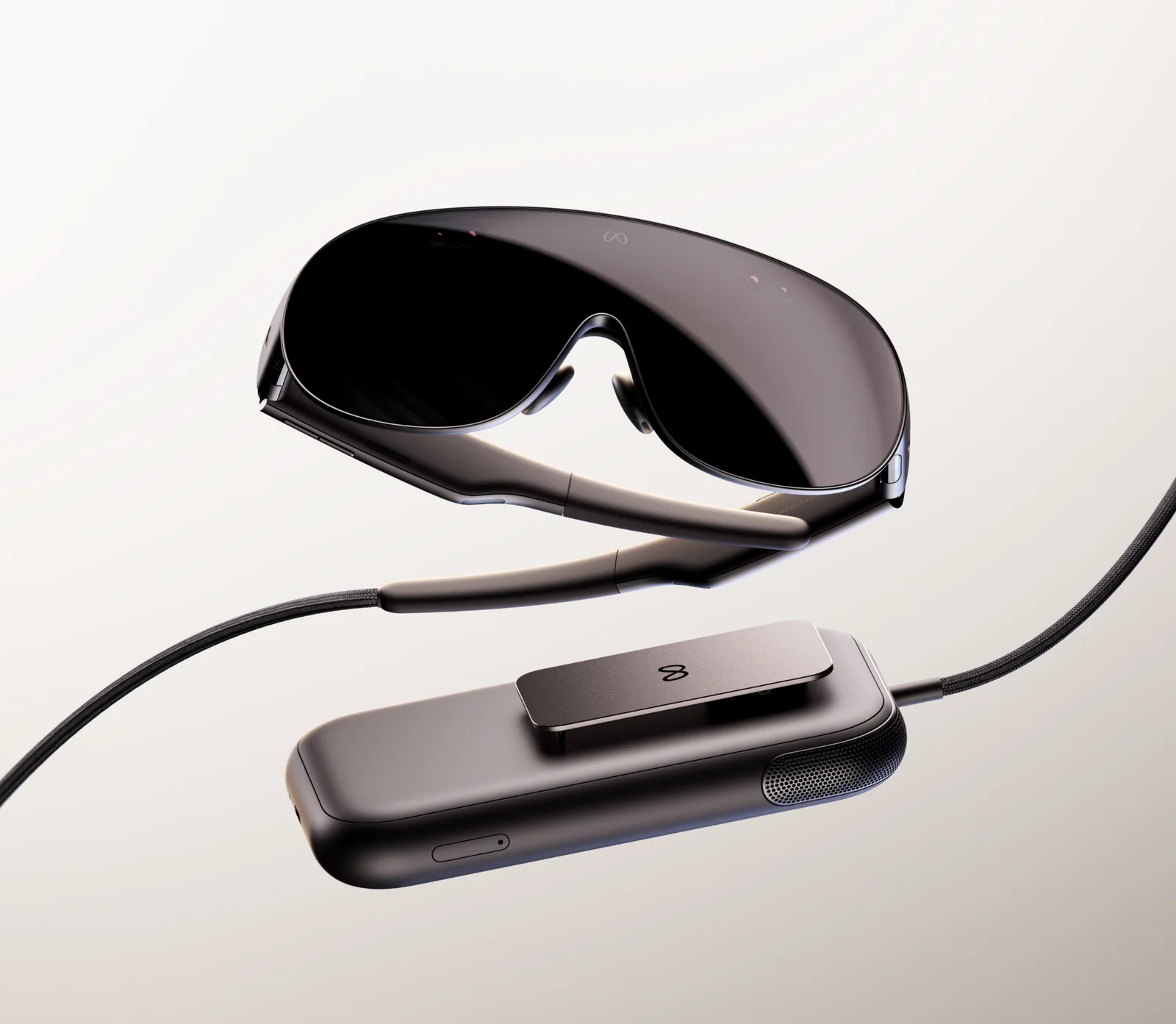 Meta VR Glasses beside the puck that handles compute, battery and storage