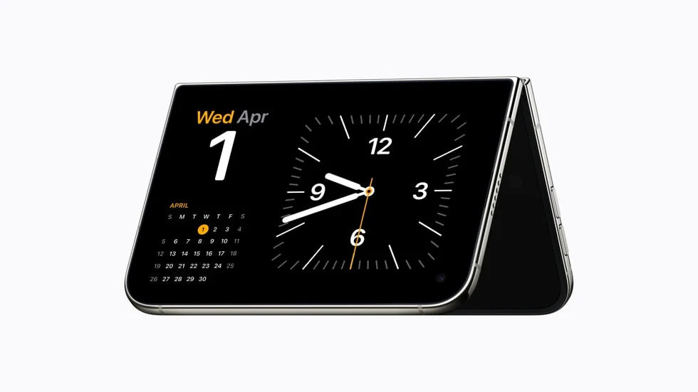 iPhone Duo propped upright in tent mode showing the StandBy clock and calendar