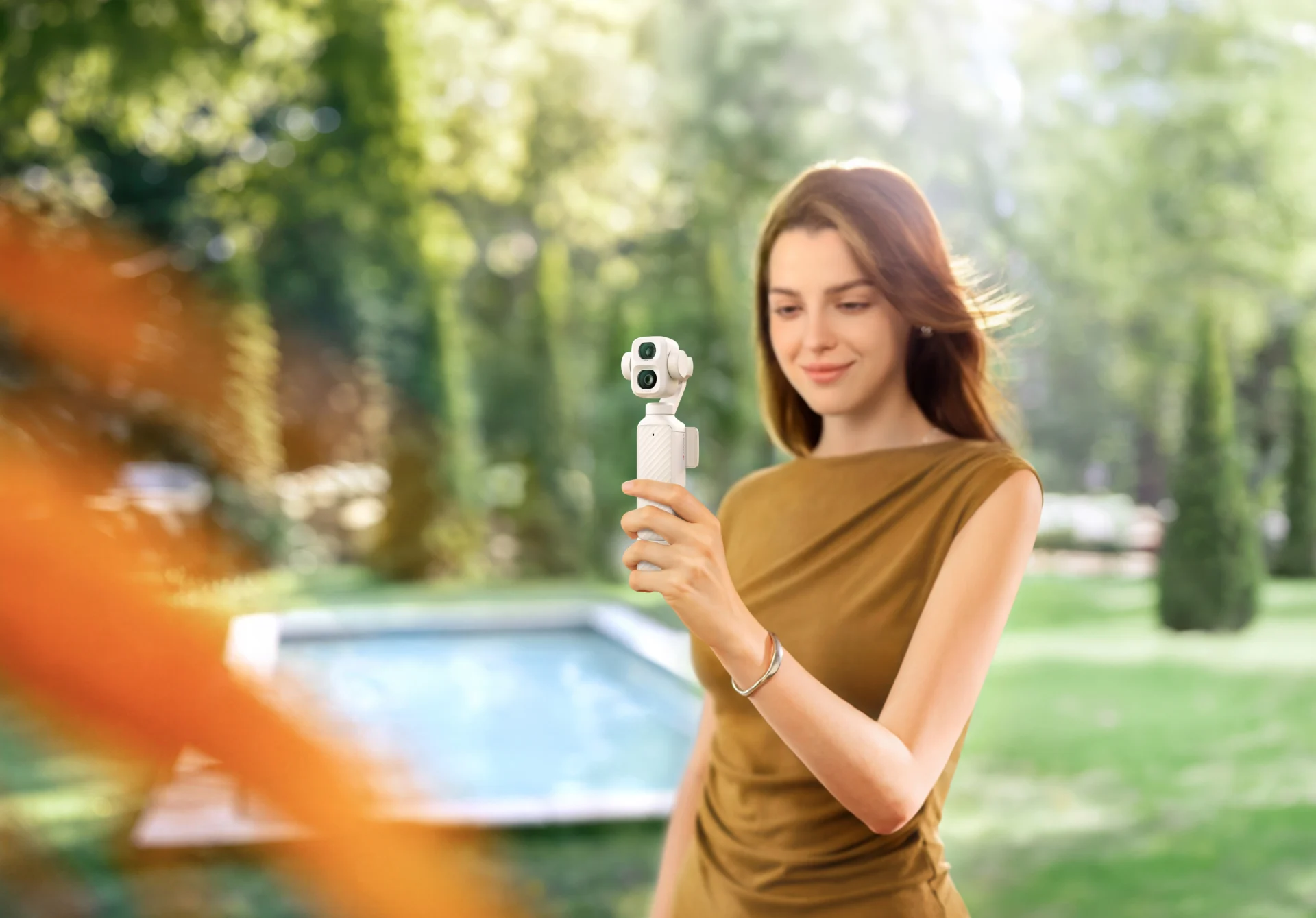 DJI Osmo Pocket 4P Pearl White gimbal camera shown outdoors in the new pearlescent finish