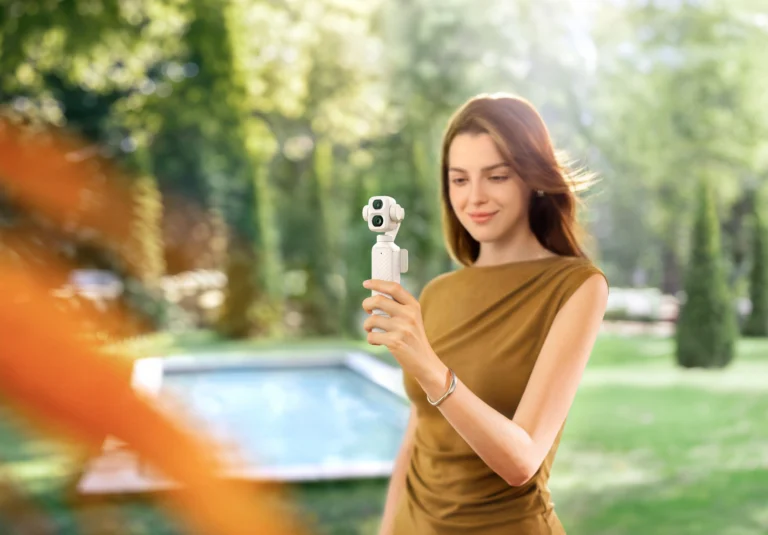 DJI Osmo Pocket 4P Pearl White gimbal camera shown outdoors in the new pearlescent finish