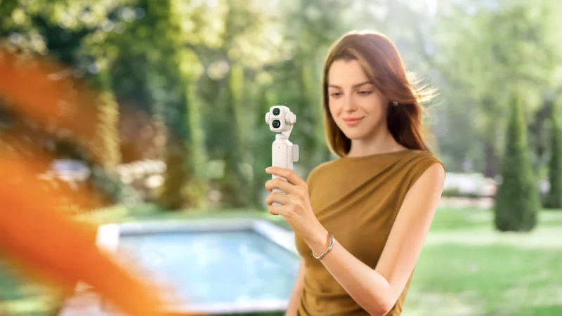 DJI Osmo Pocket 4P Pearl White gimbal camera shown outdoors in the new pearlescent finish