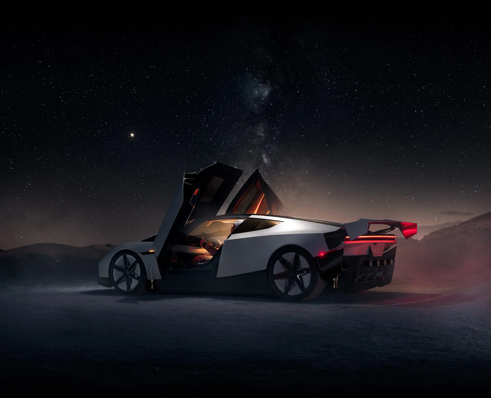 The Tesla Roadster at night with its doors open