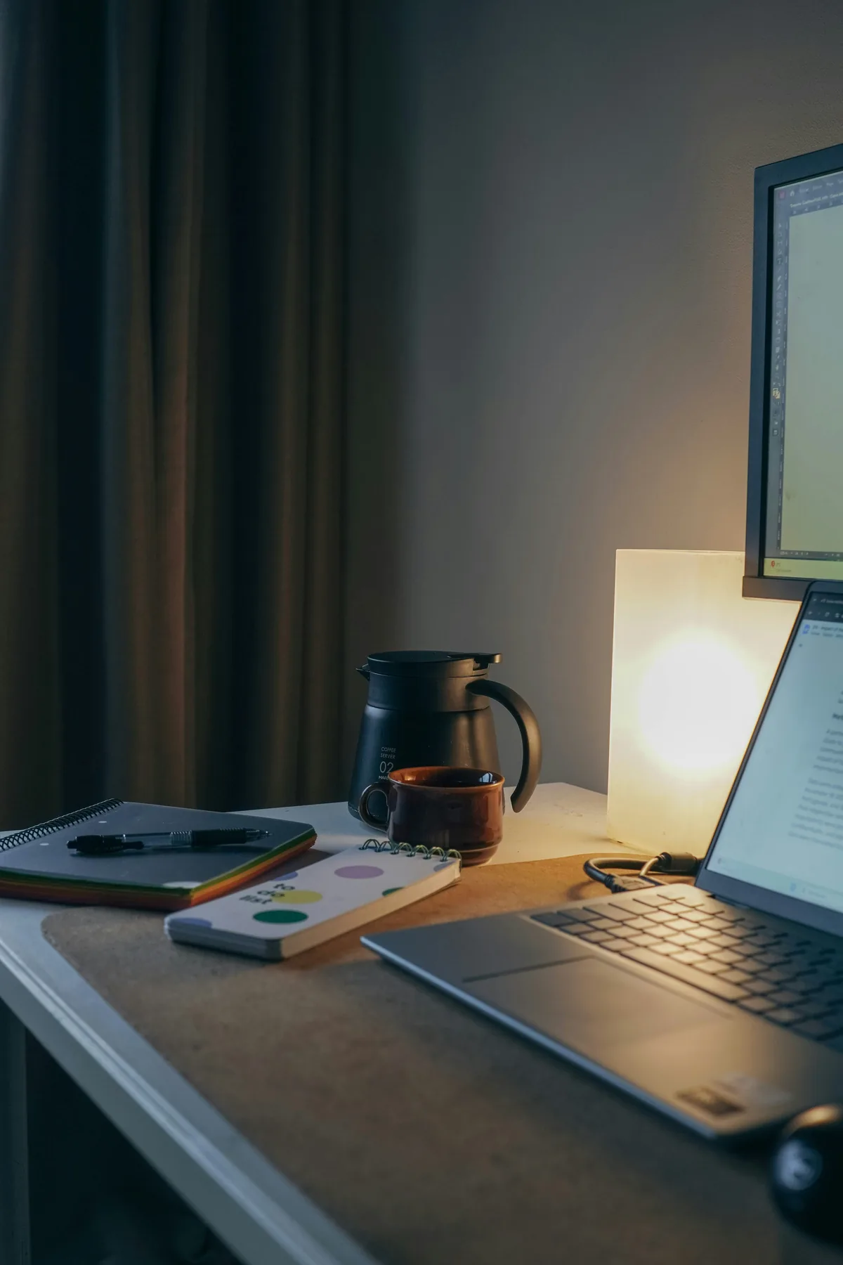 Laptop, notebook and coffee on a home desk